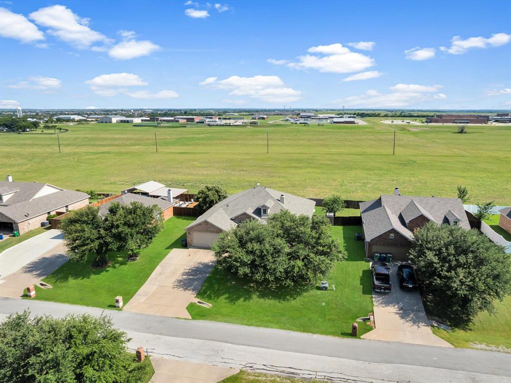 205 King George Road Ponder, TX 76259 - Photo 36 of 37 Brick exterior residence featuring a gabled roofline, an attached two-car garage, and mature landscaping