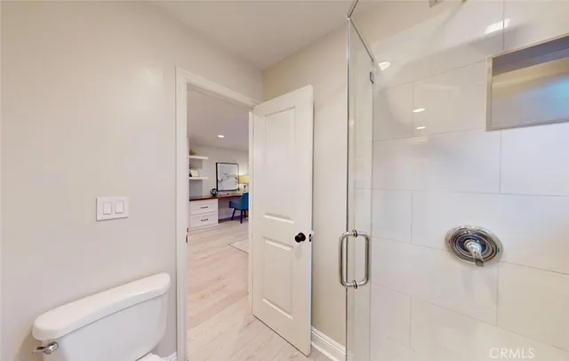 a view of a kitchen with furniture and wooden floor