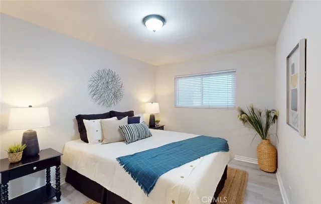 a bedroom with a bed and a painting on the wall