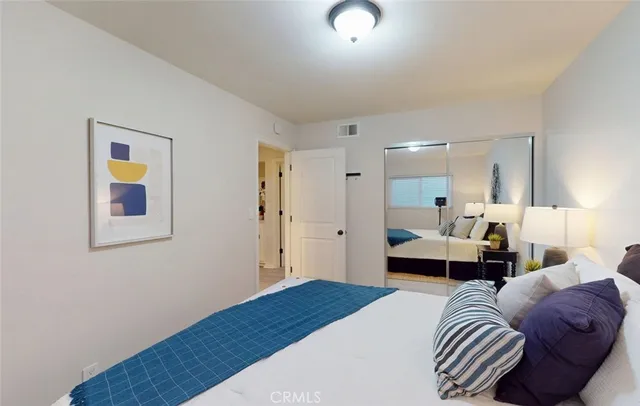 a bedroom with a bed and wooden floor