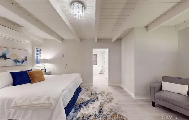 a view of a hallway with wooden floor and a potted plant