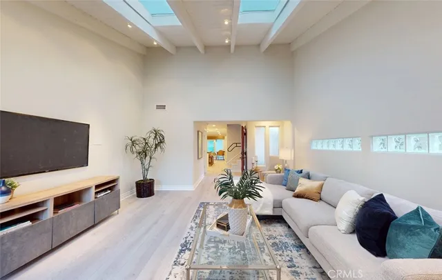 a living room with furniture a fireplace and a potted plant
