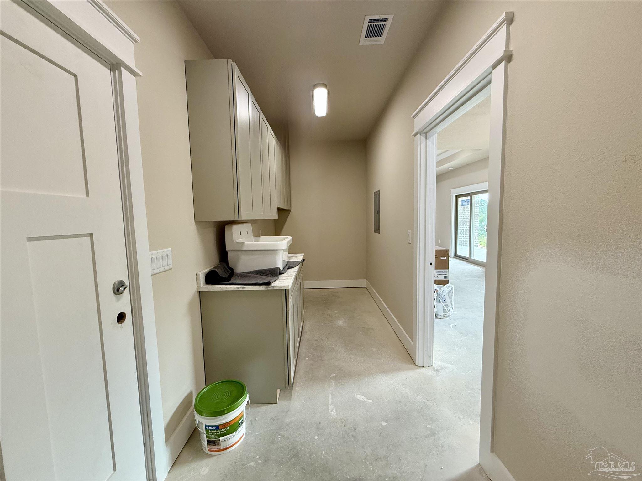 5009 Timber Ridge Drive Pace, FL 32571 - Photo 46 of 72 a room with a stove and a wooden door