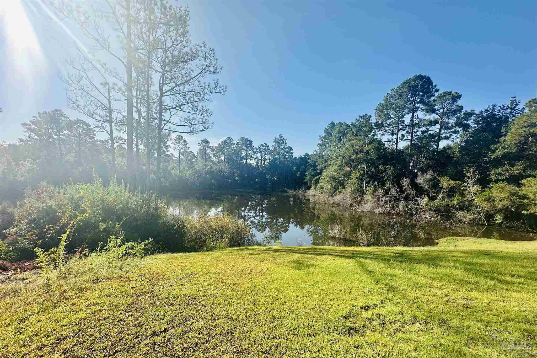 5009 Timber Ridge Drive Pace, FL 32571 - Photo 56 of 72 a view of a swimming pool with an outdoor space and seating area