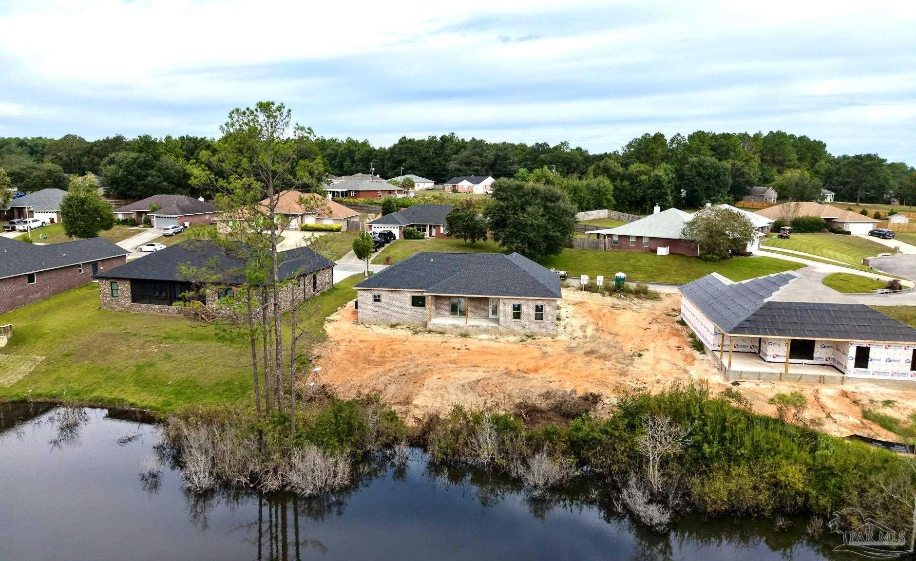 5009 Timber Ridge Drive Pace, FL 32571 - Photo 57 of 72 a view of a lake with a house