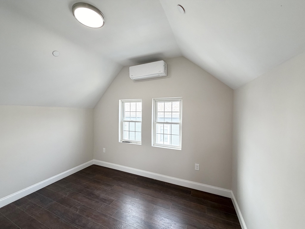 3 1/2 Buffum Street, Unit 3 Salem, MA 01970 - Photo 4 of 10 an empty room with wooden floor and windows