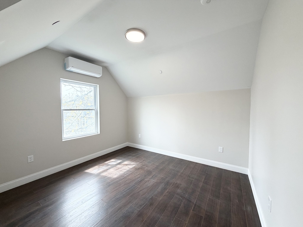 3 1/2 Buffum Street, Unit 3 Salem, MA 01970 - Photo 5 of 10 an empty room with wooden floor and windows