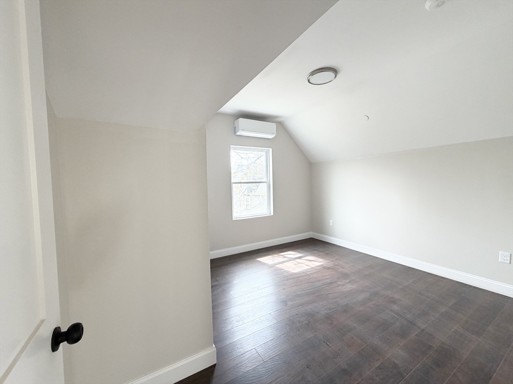 3 1/2 Buffum Street, Unit 3 Salem, MA 01970 - Photo 6 of 10 an empty room with wooden floor and windows