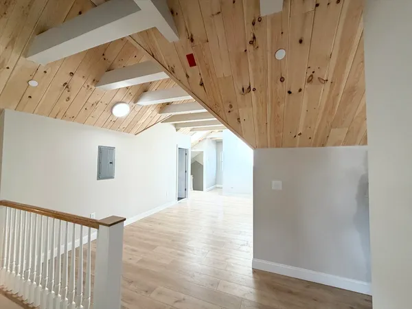 a view of a hallway with wooden floor and entryway