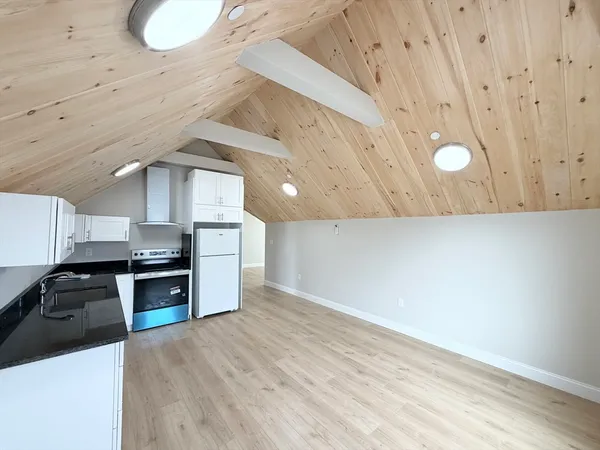 a kitchen with granite countertop a stove and a sink