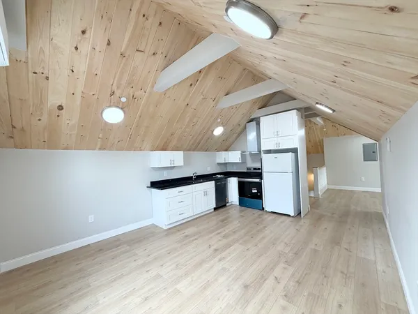 a view of a room with wooden floor