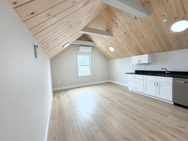 a view of a kitchen with a sink and wooden floor