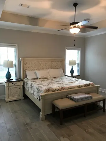 a bedroom with a bed and a chandelier