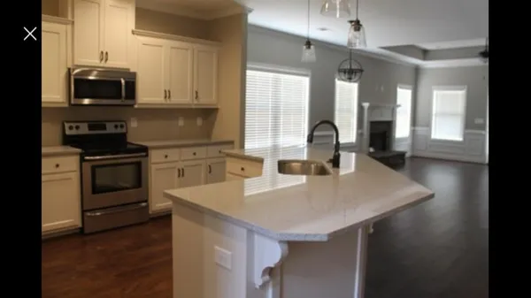 a kitchen with a sink a stove and cabinets