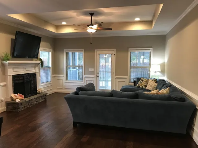 a living room with furniture and a flat screen tv