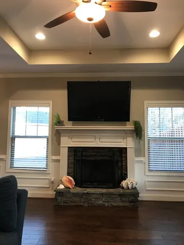 a living room with furniture a fireplace and a flat screen tv