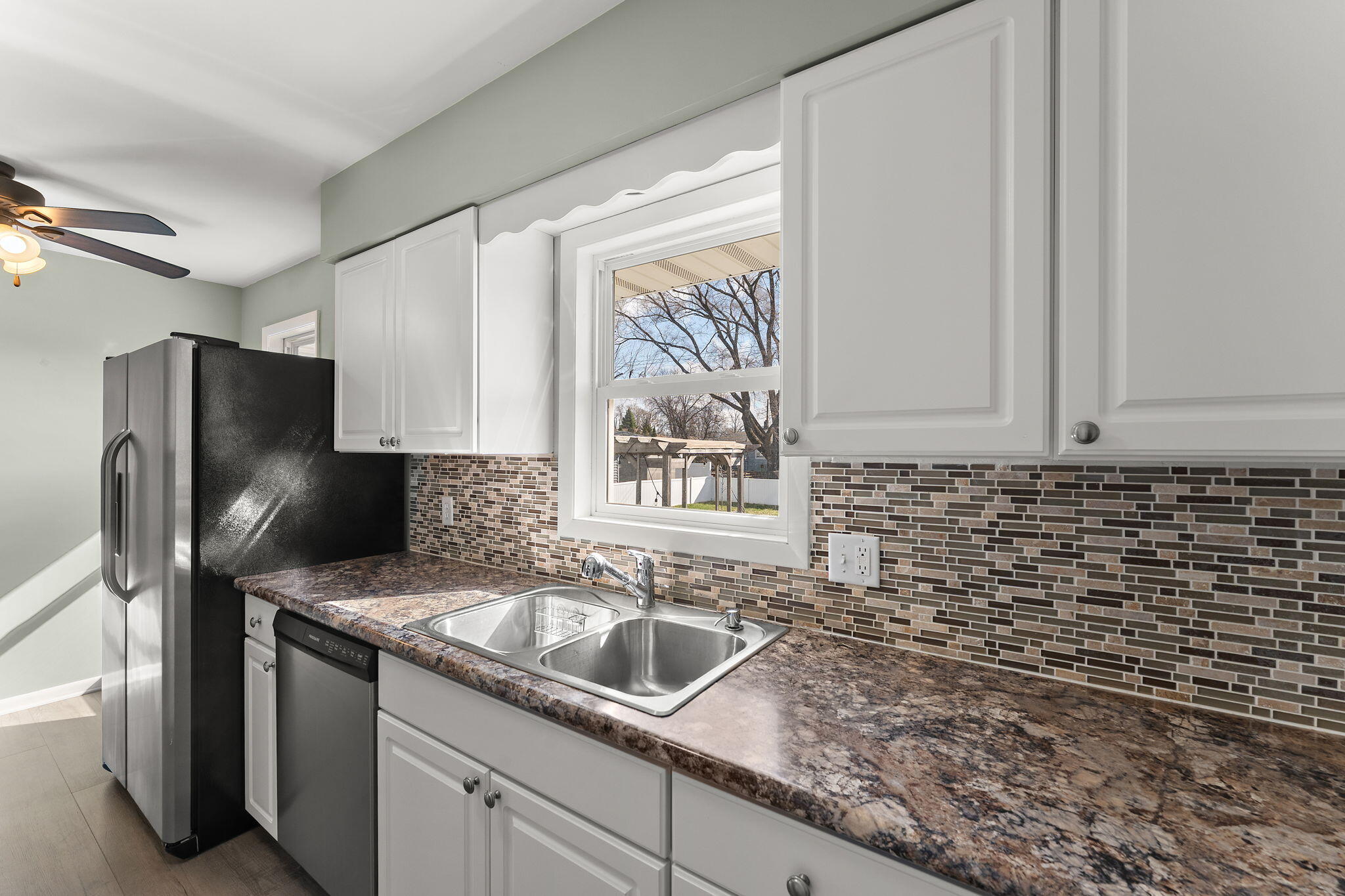 947 North Wood Street Griffith, IN 46319 - Photo 11 of 25 a kitchen with granite countertop a sink stainless steel appliances and cabinets