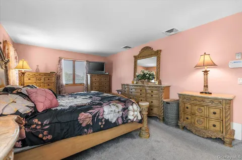 a bedroom with a bed and dresser
