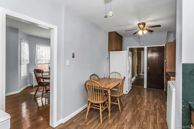 a dining room with furniture and wooden floor