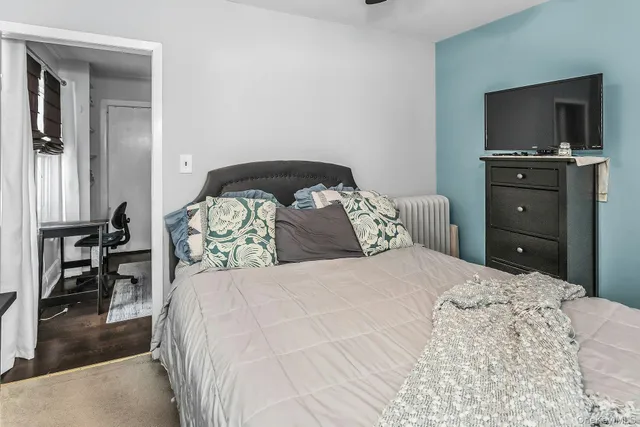 a bedroom with a bed and a television