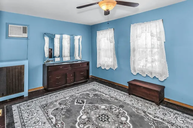 a bedroom with a bed and a chandelier fan