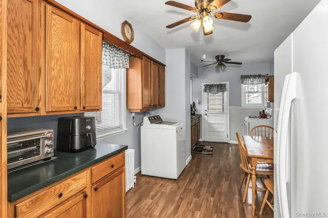 a kitchen with a refrigerator a sink and cabinets