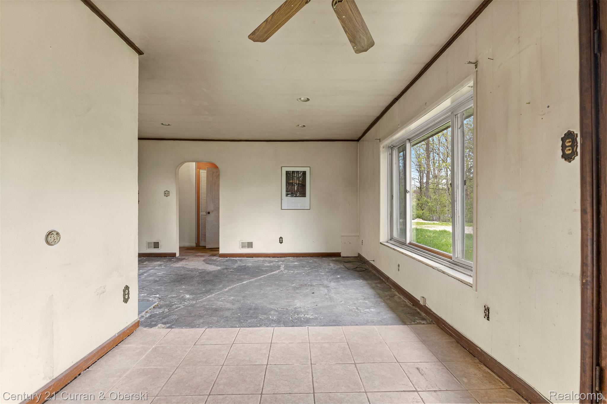 25205 Inkster Road Farmington, MI 48336 - Photo 19 of 46 Unfurnished room with arched walkways, ceiling fan, and crown molding