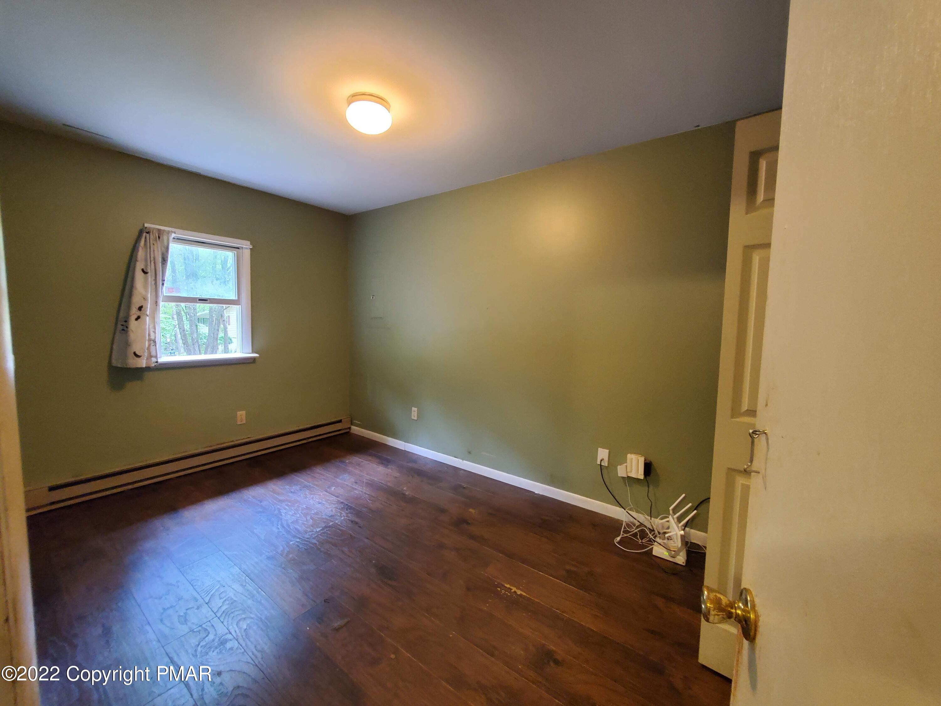 1613 Donalds Road Effort, PA 18330 - Photo 12 of 17 an empty room with wooden floor and windows