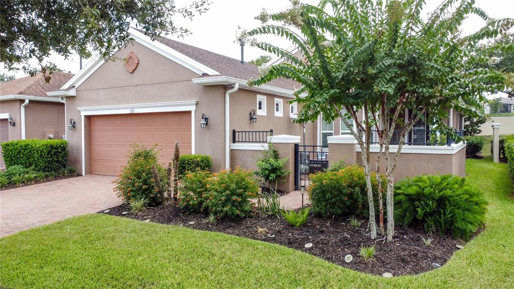 255 Silver Maple Road Groveland, FL 34736 - Photo 4 of 68 a front view of a house with garden