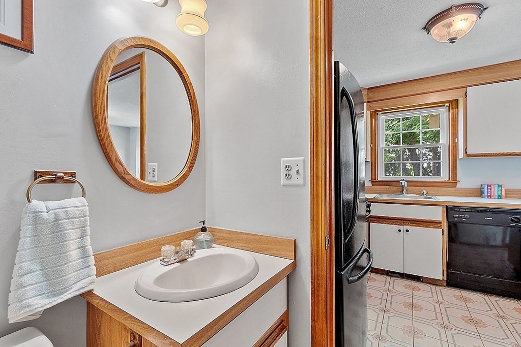 25 Juniper Place, Unit 9 Lowell, MA 01852 - Photo 14 of 42 a bathroom with a sink a mirror and a window