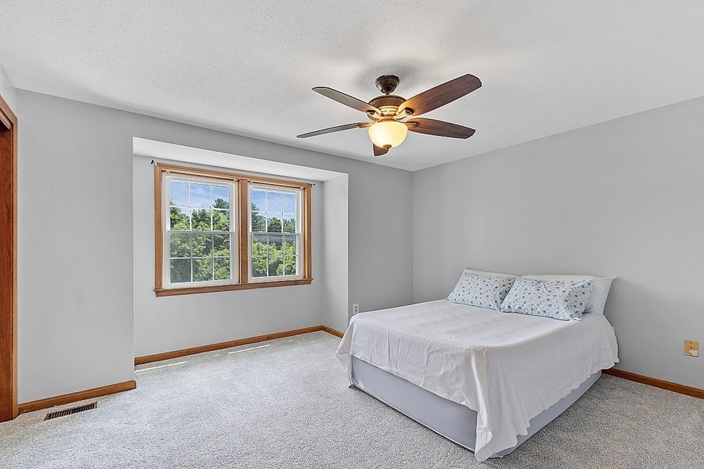25 Juniper Place, Unit 9 Lowell, MA 01852 - Photo 20 of 42 a bedroom with a bed and a large window