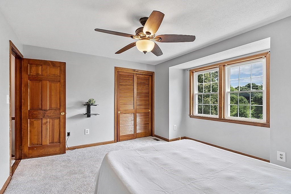 25 Juniper Place, Unit 9 Lowell, MA 01852 - Photo 21 of 42 a view of a livingroom with a ceiling fan and window