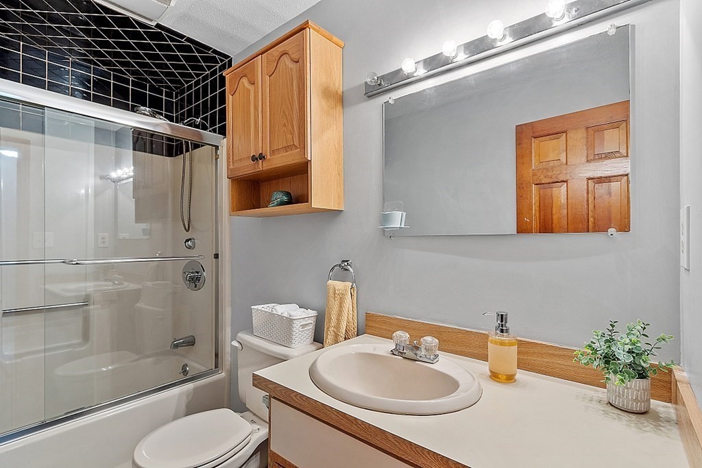 25 Juniper Place, Unit 9 Lowell, MA 01852 - Photo 27 of 42 a bathroom with a sink toilet and shower