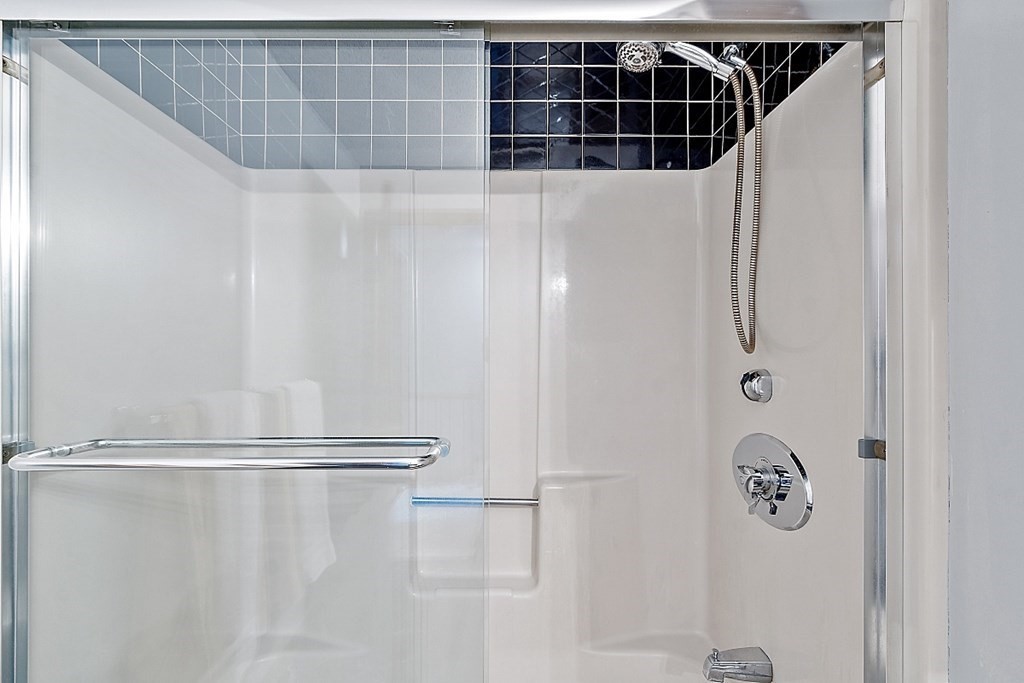 25 Juniper Place, Unit 9 Lowell, MA 01852 - Photo 28 of 42 a bathroom with a shower and a shower curtain