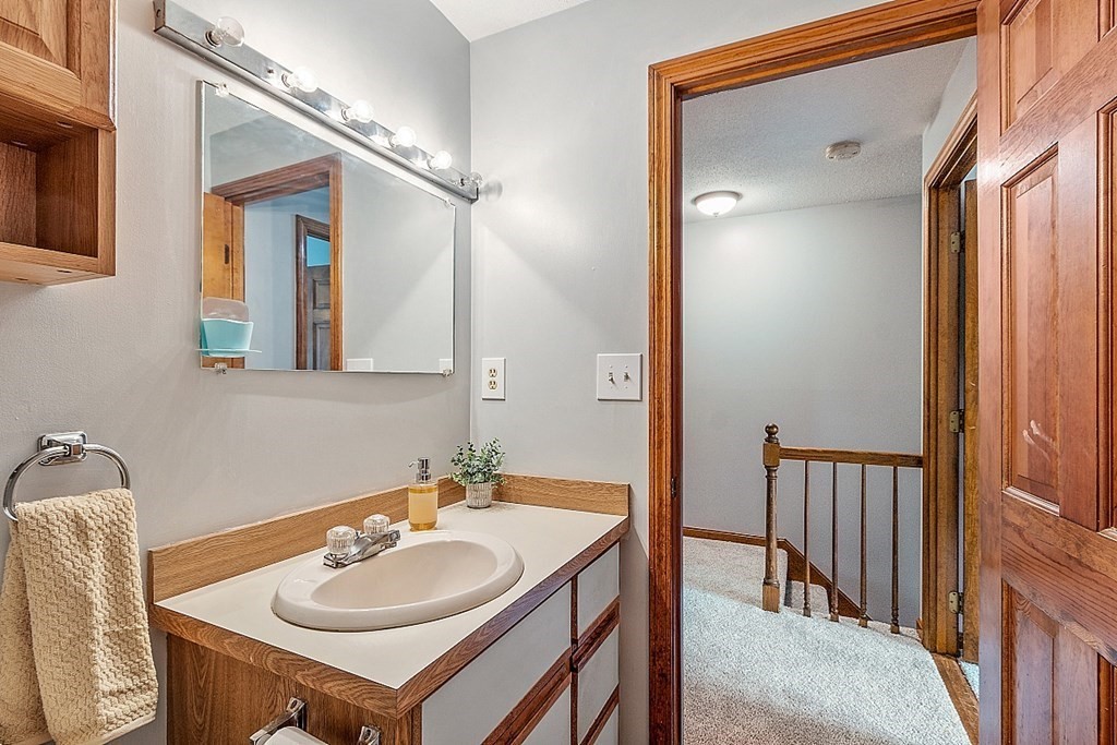 25 Juniper Place, Unit 9 Lowell, MA 01852 - Photo 29 of 42 a bathroom with a sink vanity and a mirror