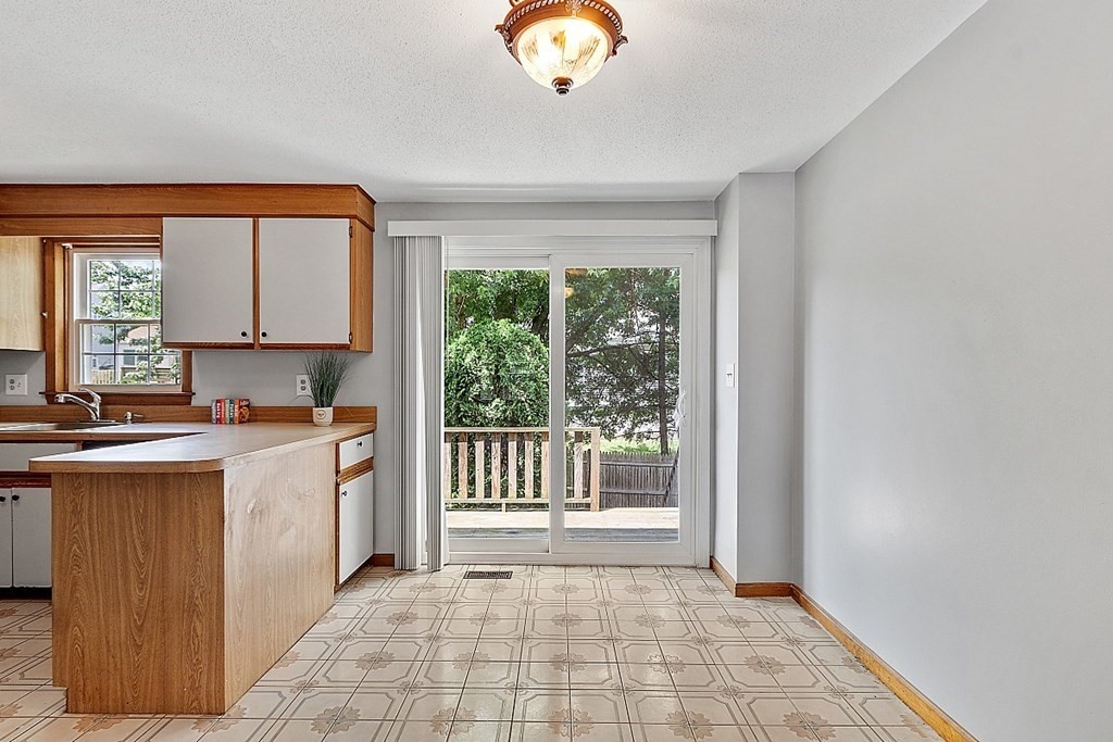 25 Juniper Place, Unit 9 Lowell, MA 01852 - Photo 3 of 42 a view of a kitchen with a sink and a window