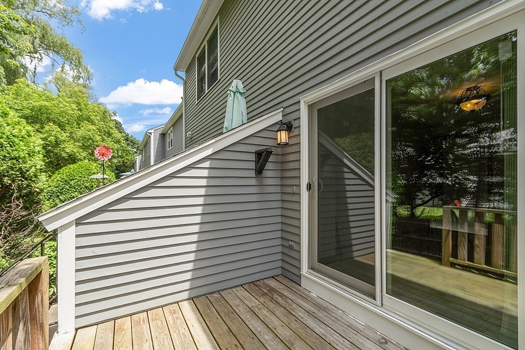25 Juniper Place, Unit 9 Lowell, MA 01852 - Photo 34 of 42 a view of a balcony with wooden floor and iron fence