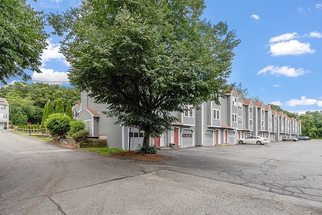 25 Juniper Place, Unit 9 Lowell, MA 01852 - Photo 39 of 42 a view of road with house and trees in the background