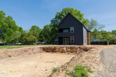 a view of a house with a yard covered with snow in front of house