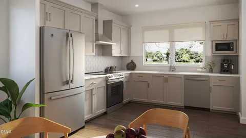 a kitchen with white cabinets stainless steel appliances a sink and a window