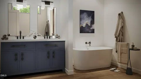 a bathroom with a double vanity sink a mirror and a bathtub