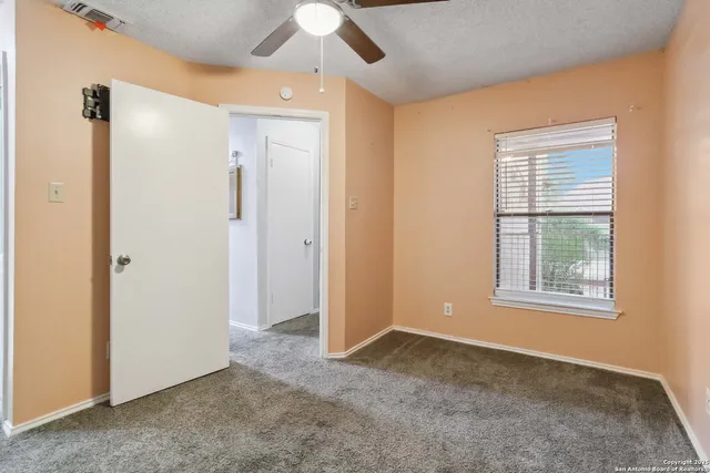 an empty room with windows and closet