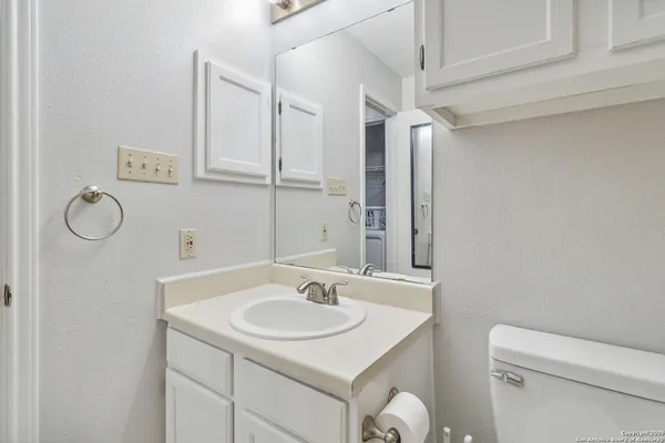 a bathroom with a sink toilet vanity and shower