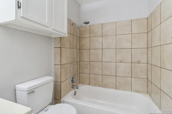 a bathroom with a bathtub and toilet