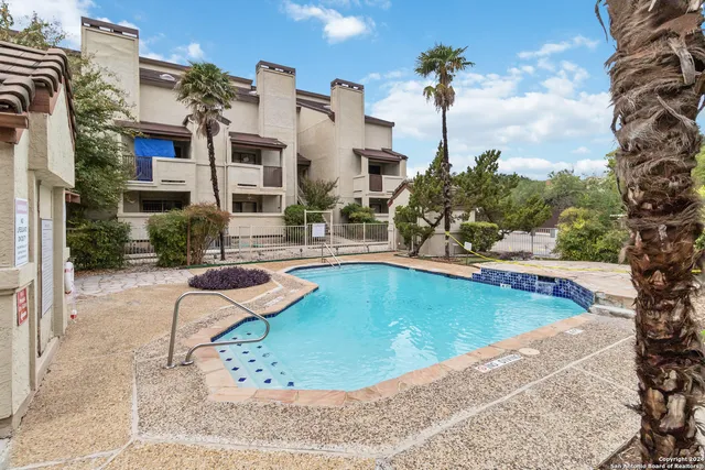 a view of a swimming pool with a patio