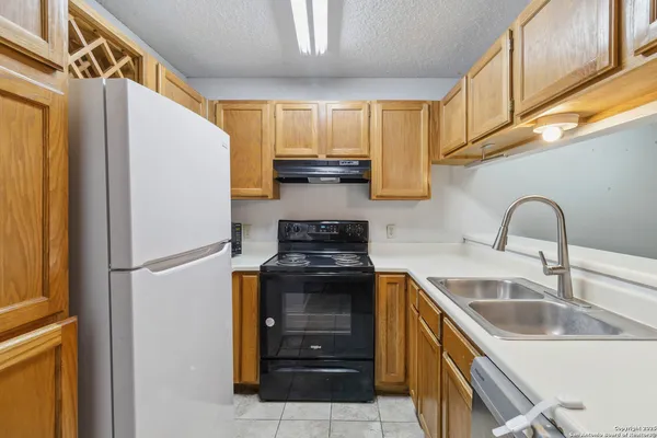 a kitchen with a sink a stove and refrigerator
