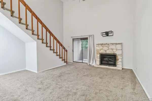 a view of empty room with fireplace and stairs