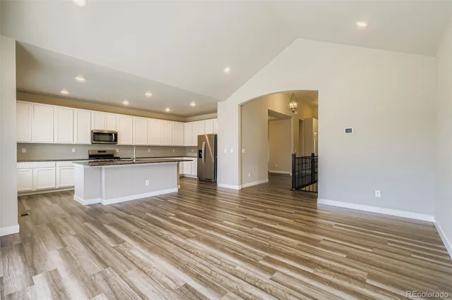 a view of kitchen view with wooden floor and cabinets