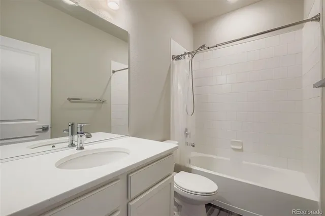 a bathroom with a sink toilet tub and shower