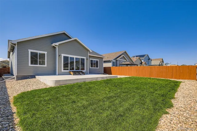 a house view with swimming pool and garden space